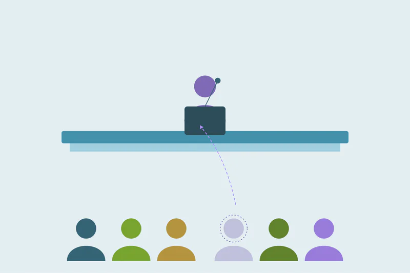 An event presenter above an audience of returning attendees